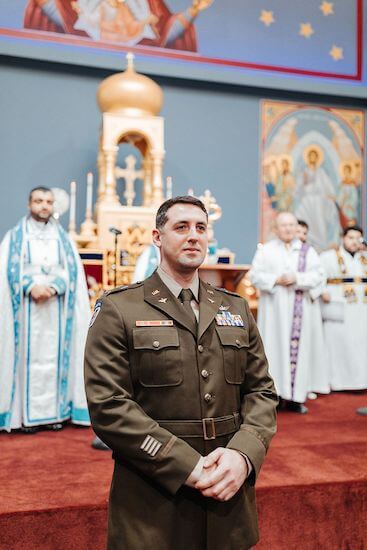 Groom in military uniforms watching his bride walk down the aisle