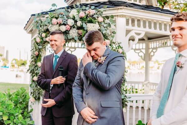 emotional groom seeing his bride to be walking down the aisle