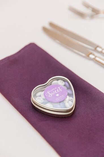 plum napkins with heart shaped wedding favor filled with M&Ms