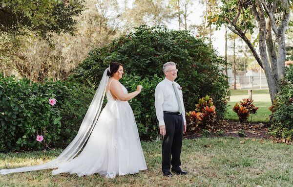 Tampa bride walking up behind her father