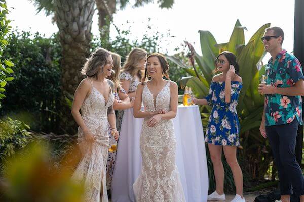 Two brides enjoying cocktail hour with thier wedding guests