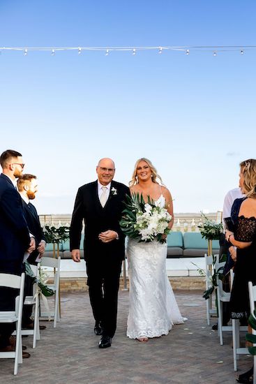 Clearwater Beach bride walking down the aisle with her father