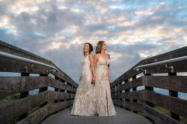 Two brides on the walkway near Belle Maison Beach House