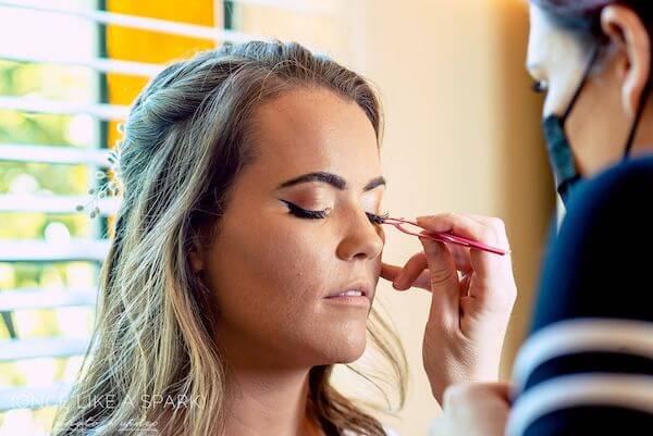 bride having makeup done on her wedding day