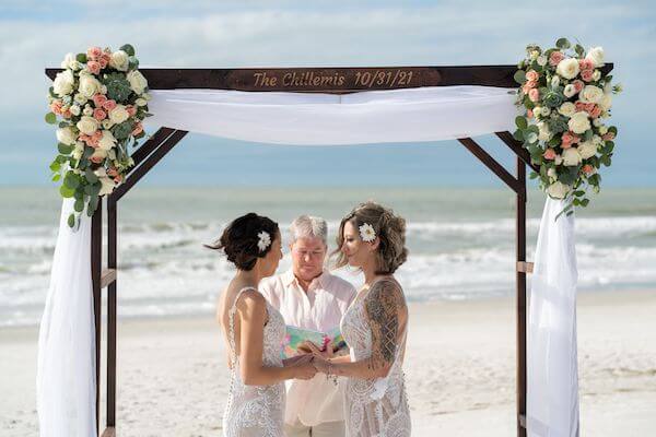 Two brides exchanging wedding vows on Indian Rocks Beach