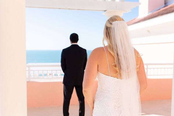 Bride walking up behind her groom for their first look