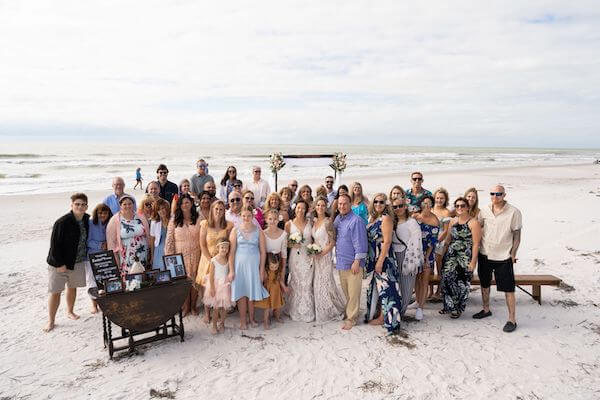 Photo of two brides and their family and friends 