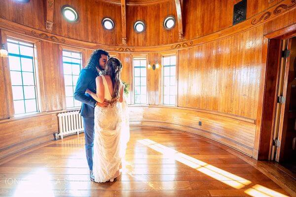 bride and groom kissing in the ship room at the Powel Crosley Estate