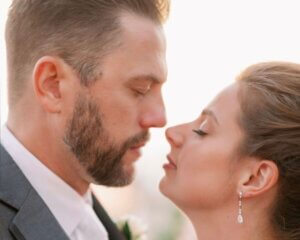 bride and groom standing nose to nose