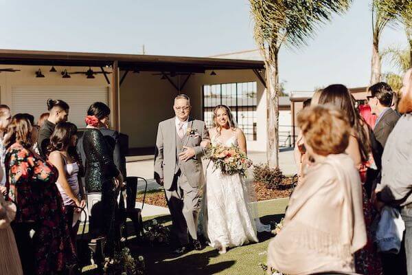 Bride walking down the aisle escorted by her father