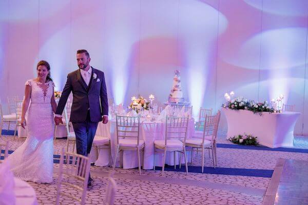 bride and groom getting a sneak peek at their Wyndham Grand Clearwater Beach wedding reception