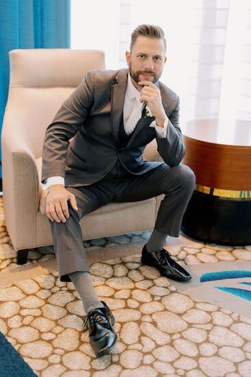 handsome groom sitting in a chair