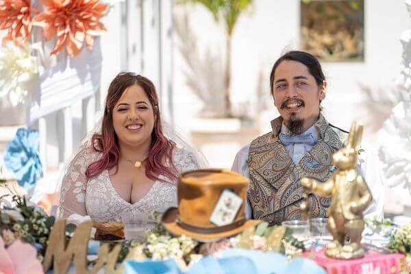 Bride and groom at their Wonderland themed sweetheart table in the Florida Botanical Gardens