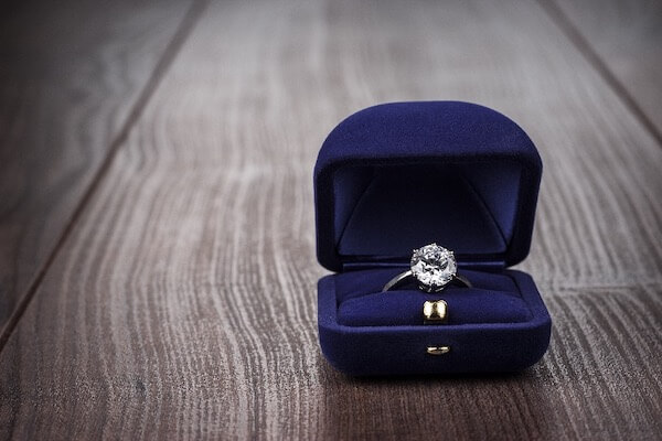 engagement ring in the box on wooden table