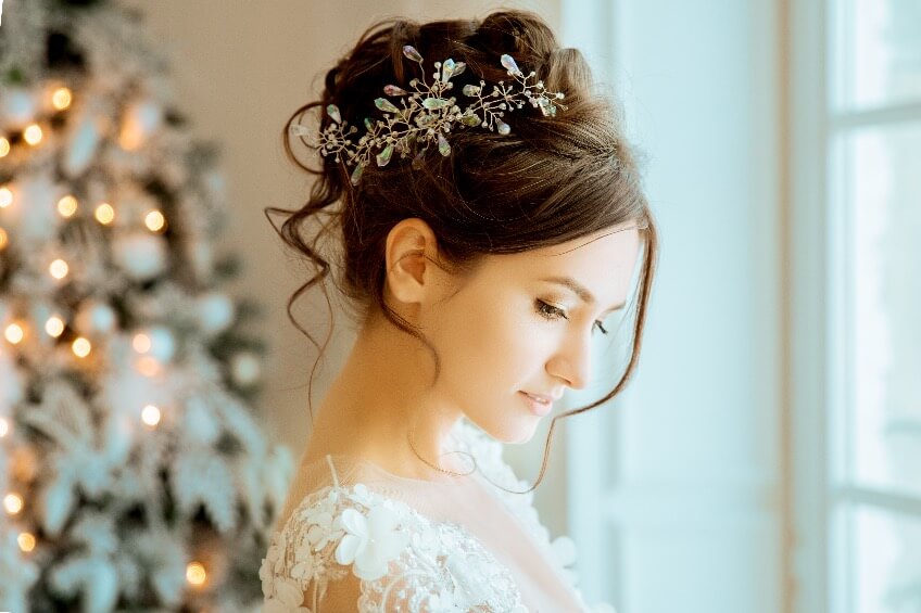 bride in front of a beautiful Christmas tree