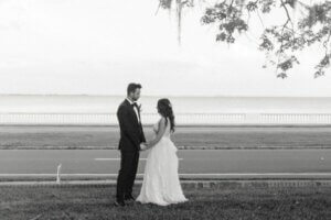 Bride and groom standing along Tampa Bay