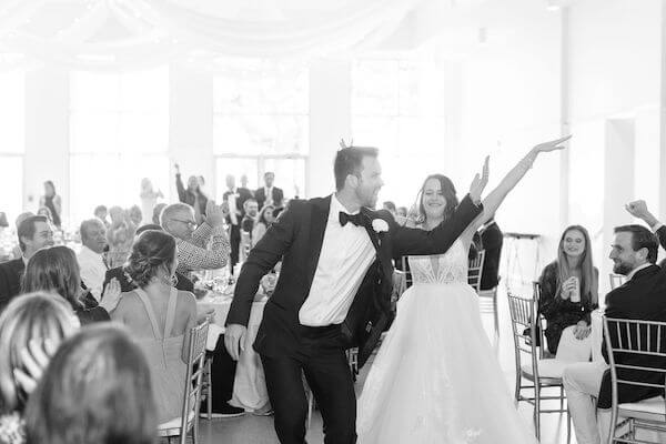 Excited bride and groom making their grand entrance