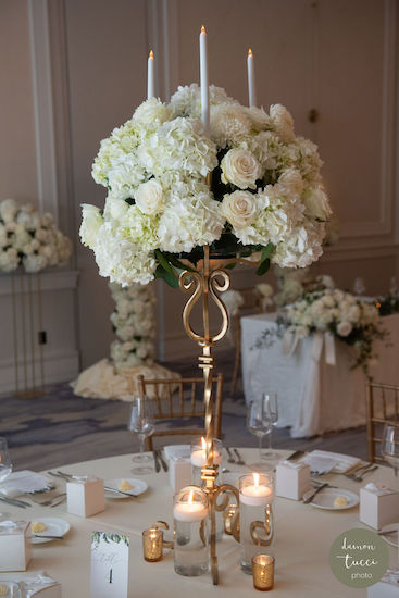 Gold candelabra with white flowers at a Tampa Bay wedding reception 