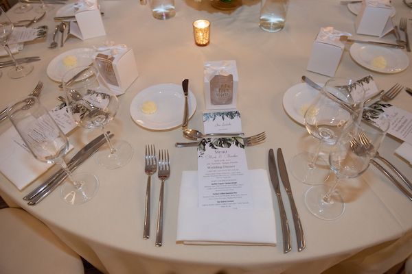 Guests' place setting with custom menu card, place card and favor