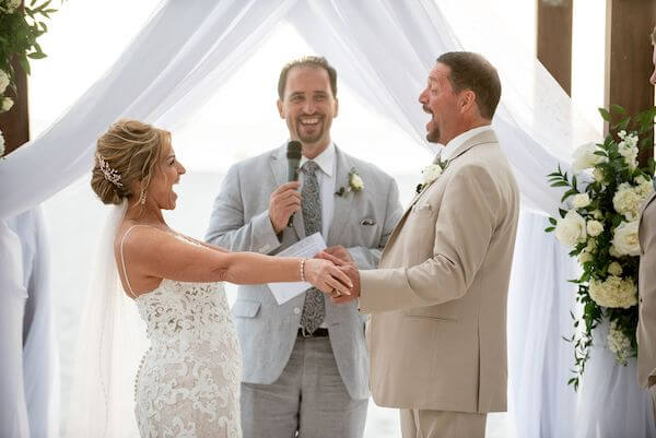 Bride and groom laughing during their wedding ceremony