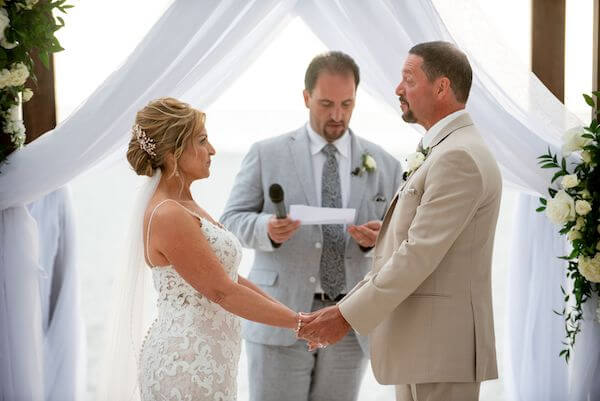 Bride and groom exchanging wedding vows on Clearwater Beach