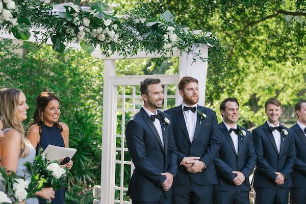 Groom watching his bride-to-be walk down the aisle