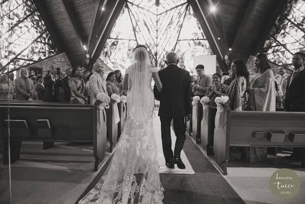 bride being escorted down the aisle by her father