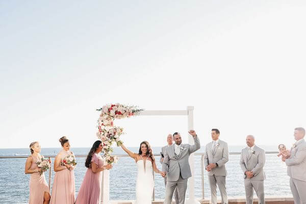 Bride and groom's exit their Clearwater Beach wedding to the theme from Rocky