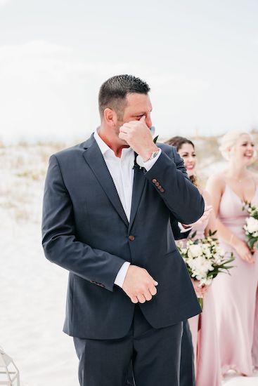 Groom crying when he sees his bride