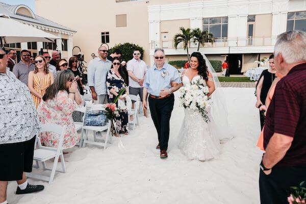 Bride walking down the aisle with her father at her Sandpearl Resort wedding