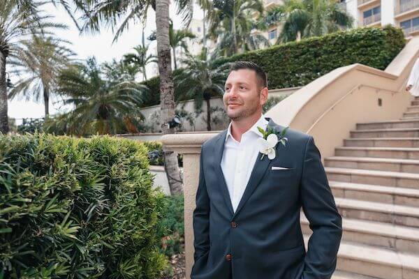 Handsome groom taking photos at the Sandpearl Resort