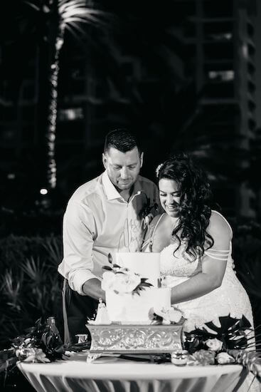 Bride and groom cutting their wedding cake