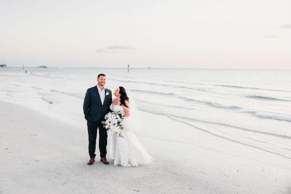 Newlywed couple on Clearwater Beach at sunset