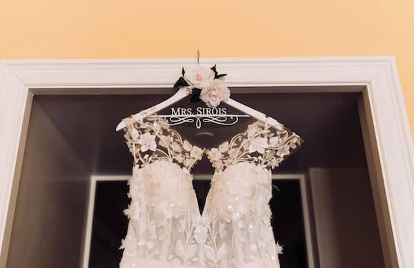 Beautiful lace wedding gown on a custom hanger