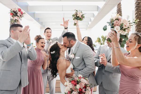 Gride and groom taking photos with their wedding party after their first look