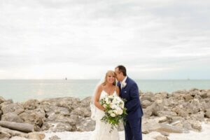 The groom kissing his bride's face on the Clearwater Beach jetty