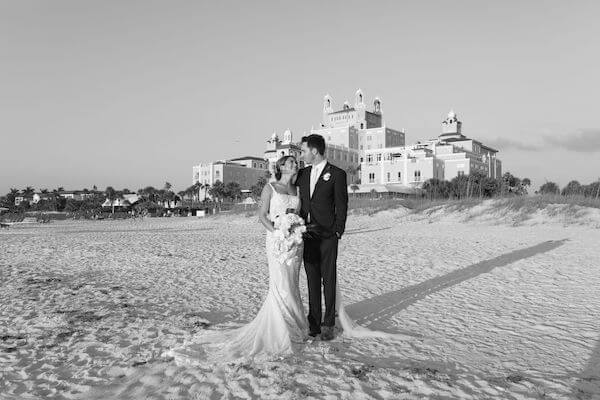 Black and white photo of a bride and groom on St Pete Beach near the Don Cesar