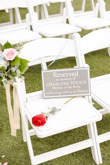 Reserved seat and a red rose in memory of the bride's mother