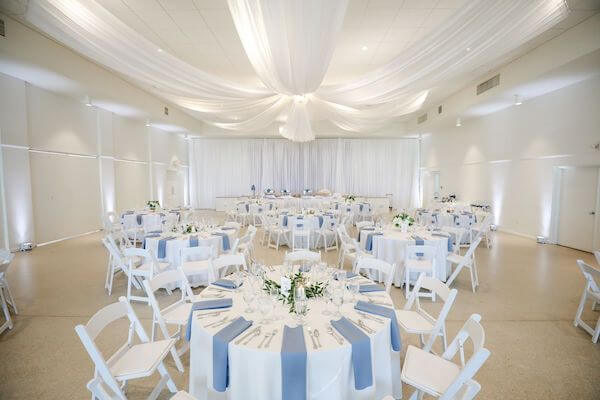 Tampa Garden Club ballroom set for a white and blue wedding reception