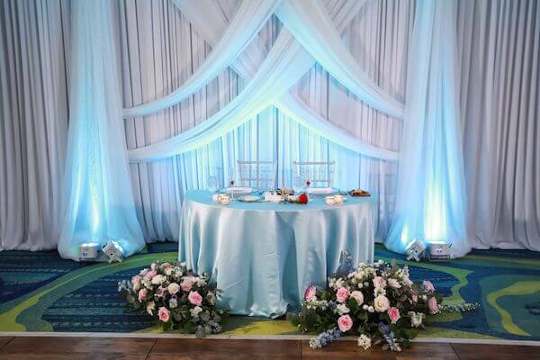 Sweetheart table with beautiful draping and lighting