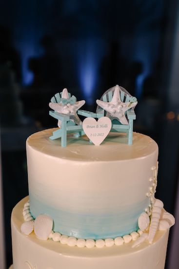 Beach themed wedding cake with a bride and groom starfish