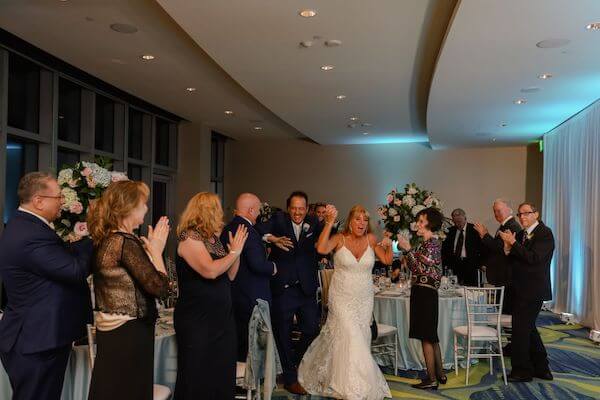 Bride and groom's grand entrance at their opal sands wedding reception