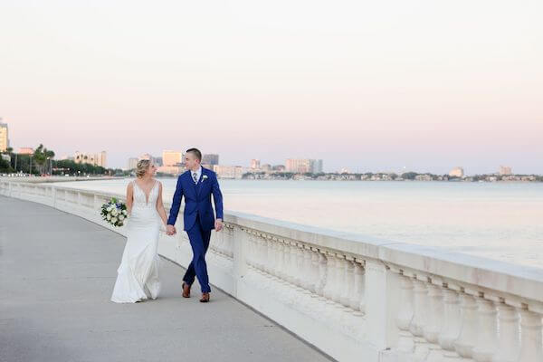 Bride and groom taking sunset photos along Tampa Bay