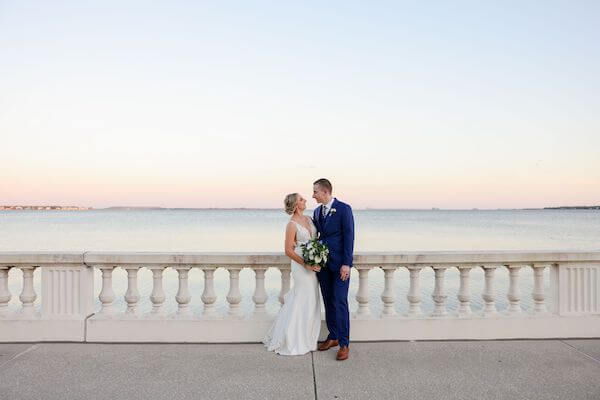 Bride and groom taking sunset photos along Tampa Bay