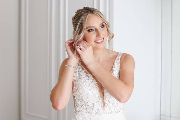 Bride adding finishing touches to her wedding attire