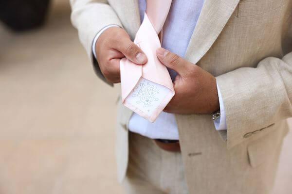 Groom showing his personalized wedding tie