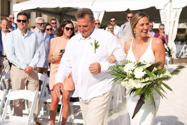 Excited bride walking down the aisle with her dad