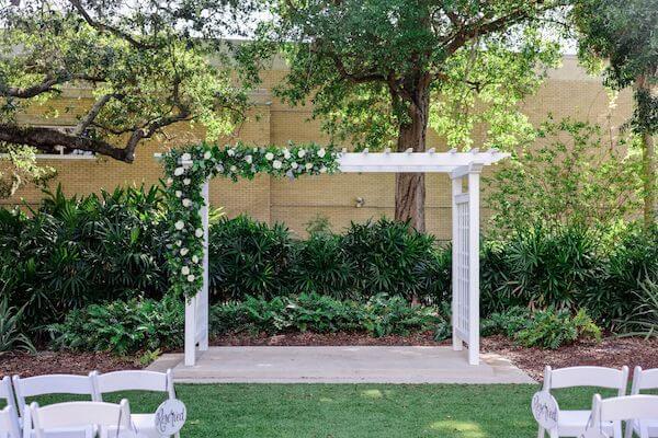 Wedding arch with white flowers at the Tampa Garden Club