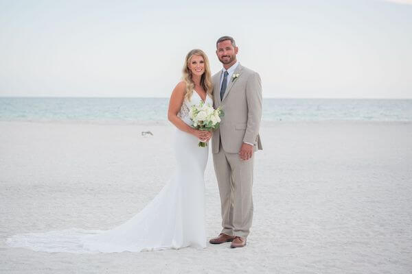 Bride and groom standing next to the Gulf of Mexico at the Strata Beach Resort on St. Pete Beach