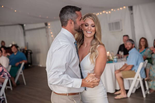 Brid mand groom's first dance under a tent at the Strata Beach Resort